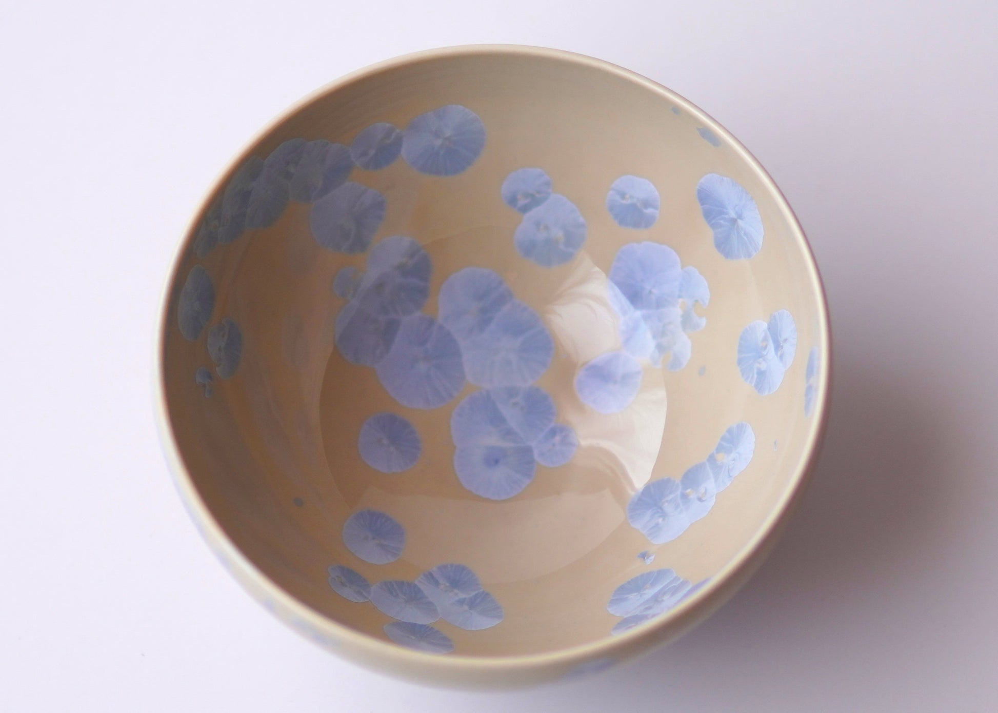 Ceramic bowl with blue floral patterns on a white background